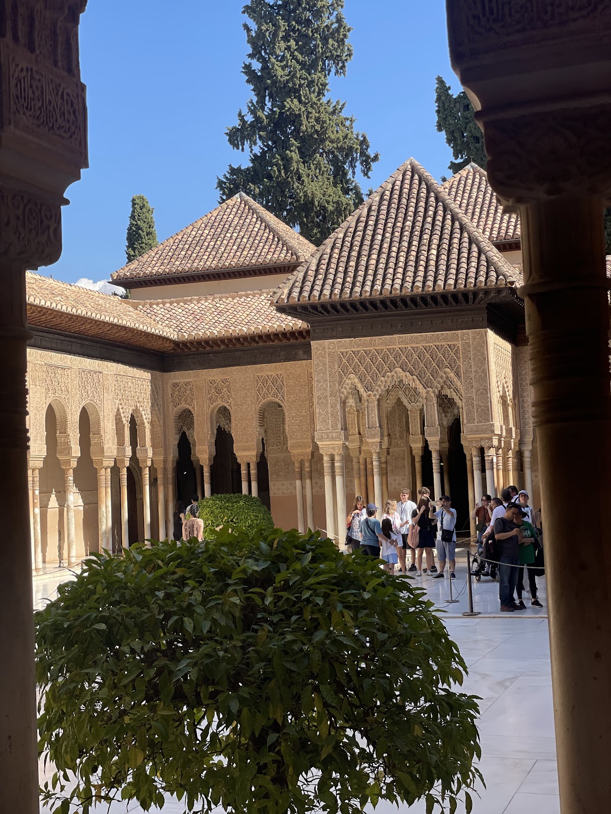 Interior of the Nasrid Palaces in the Alhambra, Granada — intricate Moorish carvings and reflecting pools