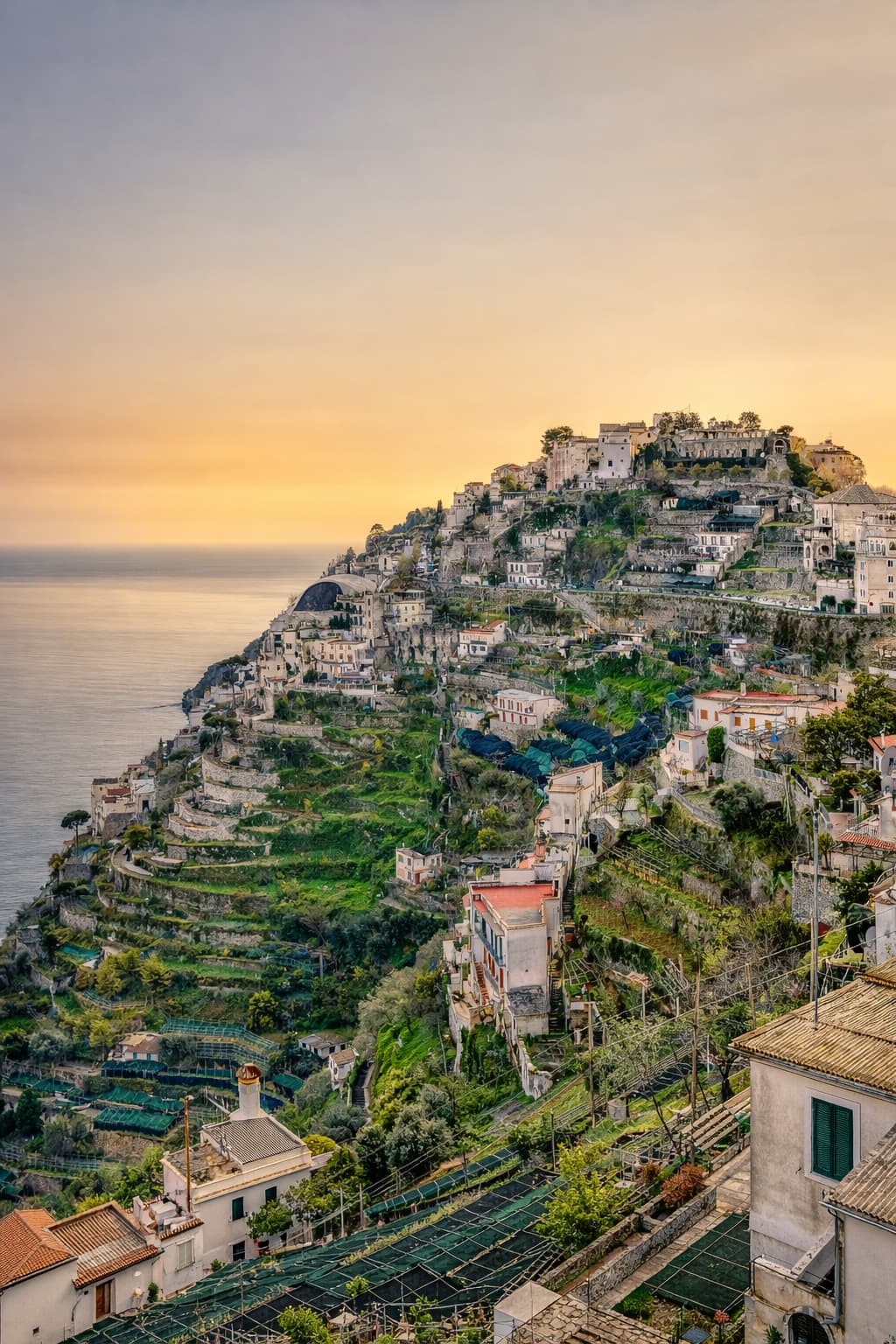 Aerial view of Praiano's church dome and rooftops above the sea, one of the quietest Amalfi Coast towns on the route