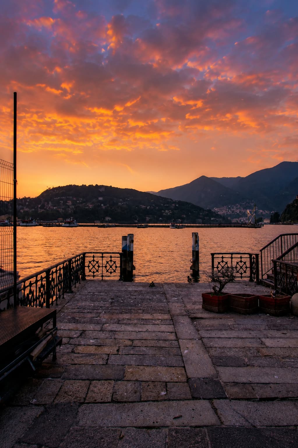 Lake Como at sunset from a lakeside promenade in northern Italy