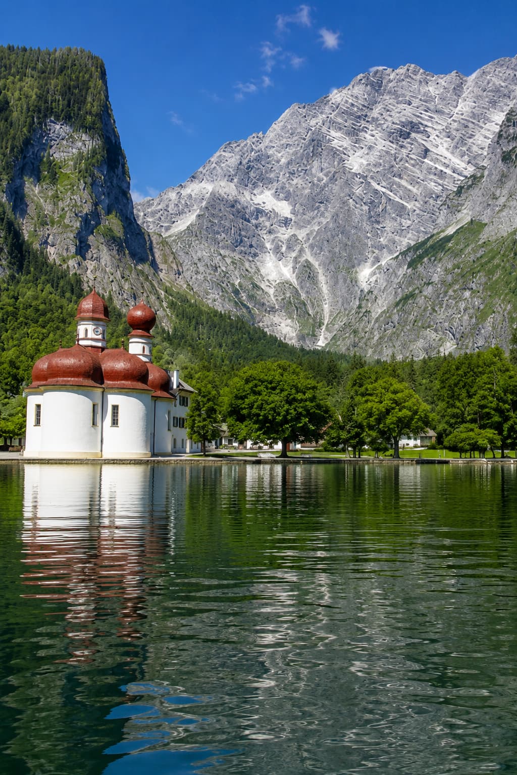St. Bartholomä chapel on Königssee beneath limestone cliffs in Berchtesgaden