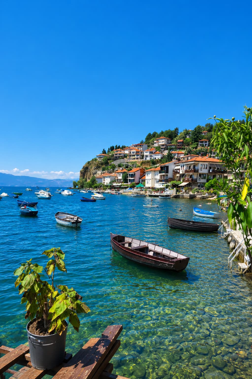 Lake Annecy waterfront with flowers and boats in the French Alps