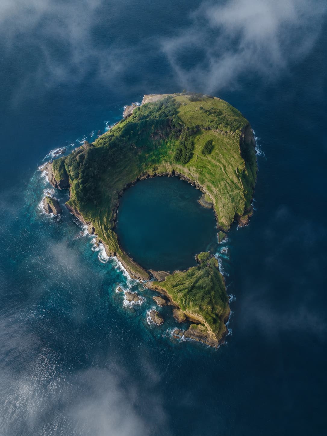 Aerial view of the round green Vila Franca islet ringed by deep blue Atlantic off the coast of São Miguel, Azores