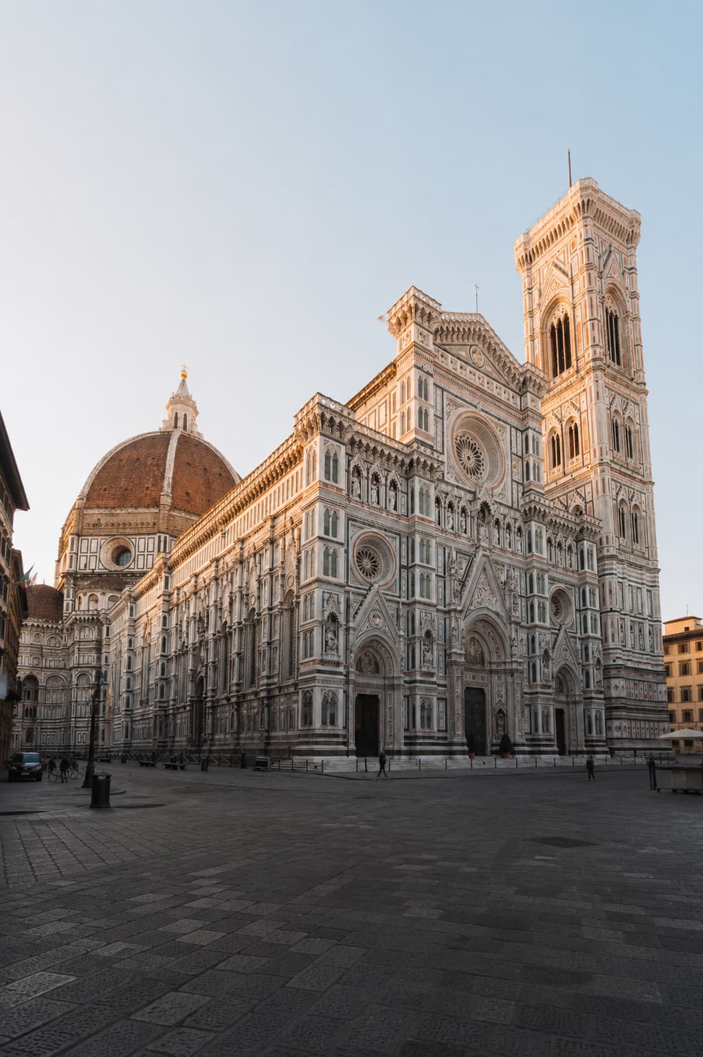Things to do in Florence start at the Duomo, its marble facade and Brunelleschi's dome rising over an empty piazza at dawn