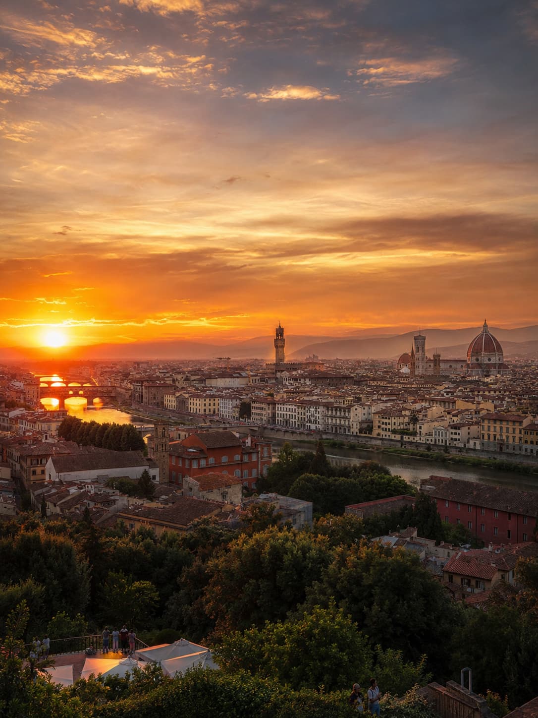 Sunset view over Florence from Piazzale Michelangelo, with the Palazzo Vecchio tower, the Duomo, and the Arno bridges below