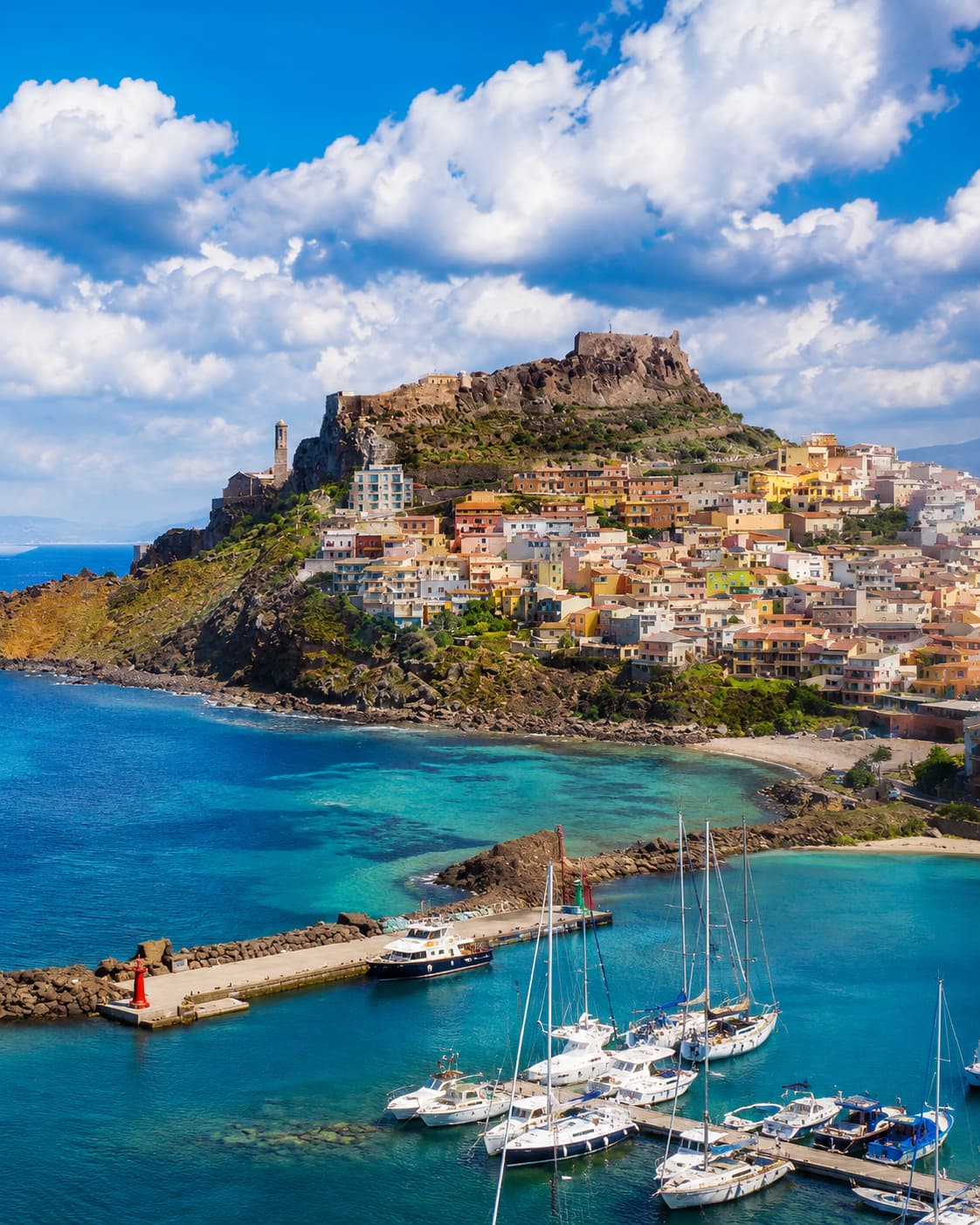 The hilltop castle town of Castelsardo with colourful houses and a small marina on the north coast of Sardinia