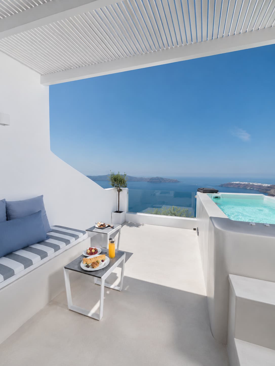 Santorini vs Mykonos: a caldera-view terrace with plunge pool overlooking the Aegean in Santorini
