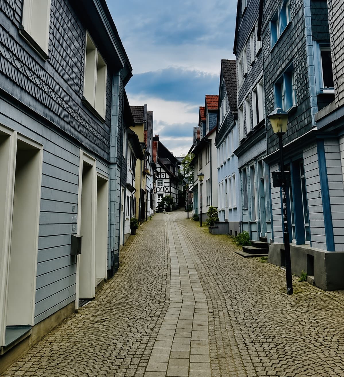 travel backpack on cobblestone street in Europe minimalist packing for europe trip