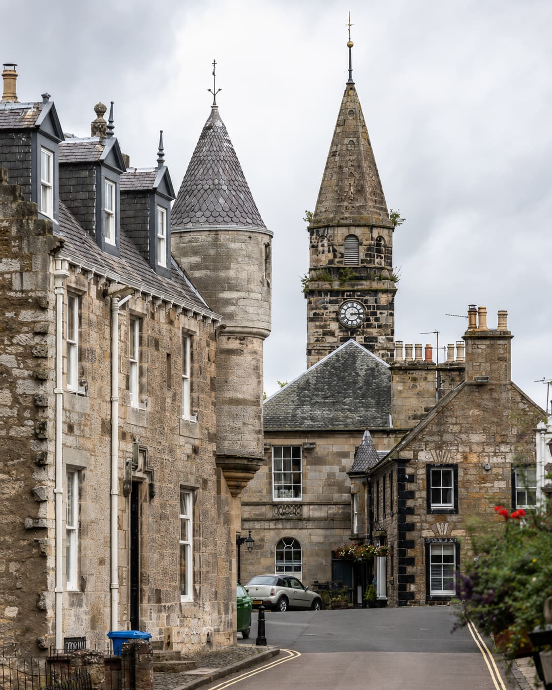 Falkland village Fife Scotland — cobbled street lined with stone buildings, church clock tower, one of the most picturesque Scottish villages and Outlander filming location for 1940s Inverness