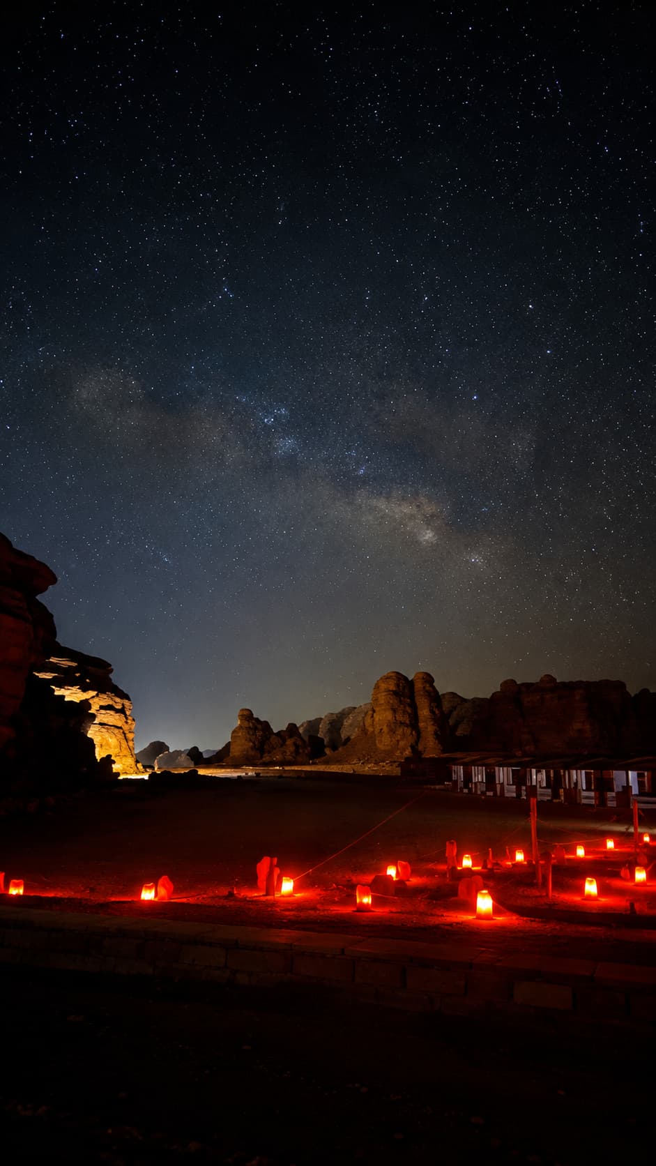 A Wadi Rum desert camp glowing under the Milky Way and a sky full of stars at night