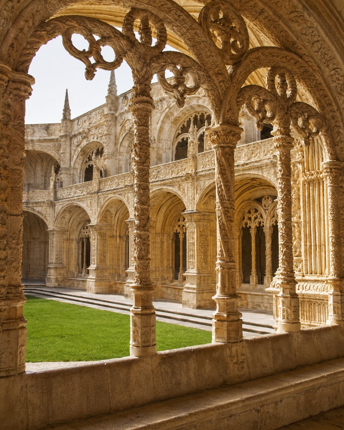 Jerónimos Monastery cloister in Belém Lisbon showing ornate Manueline stone arches and columns