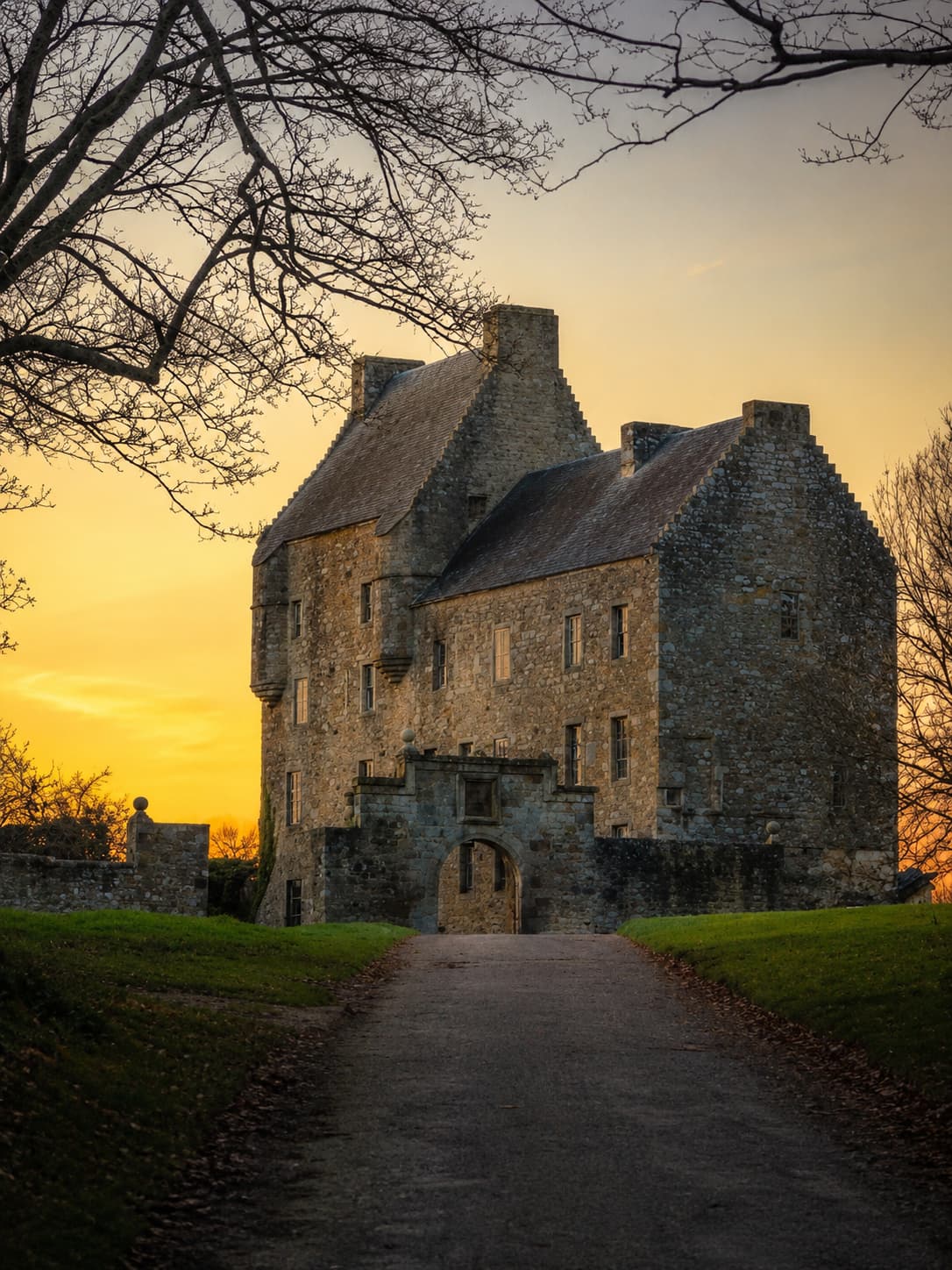 Midhope Castle at golden hour — the real Outlander filming location for Lallybroch, Jamie Fraser's ancestral home, on the Hopetoun Estate near Edinburgh