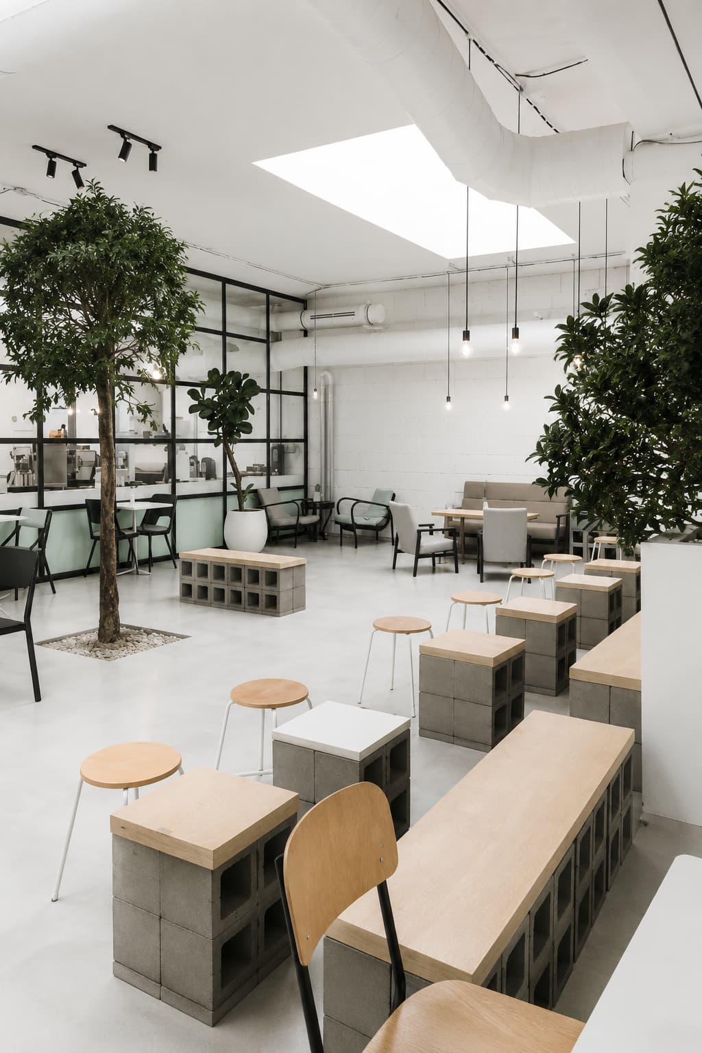 Bright modern café interior in Prague with indoor trees and skylights — best cafes in Prague for contemporary design