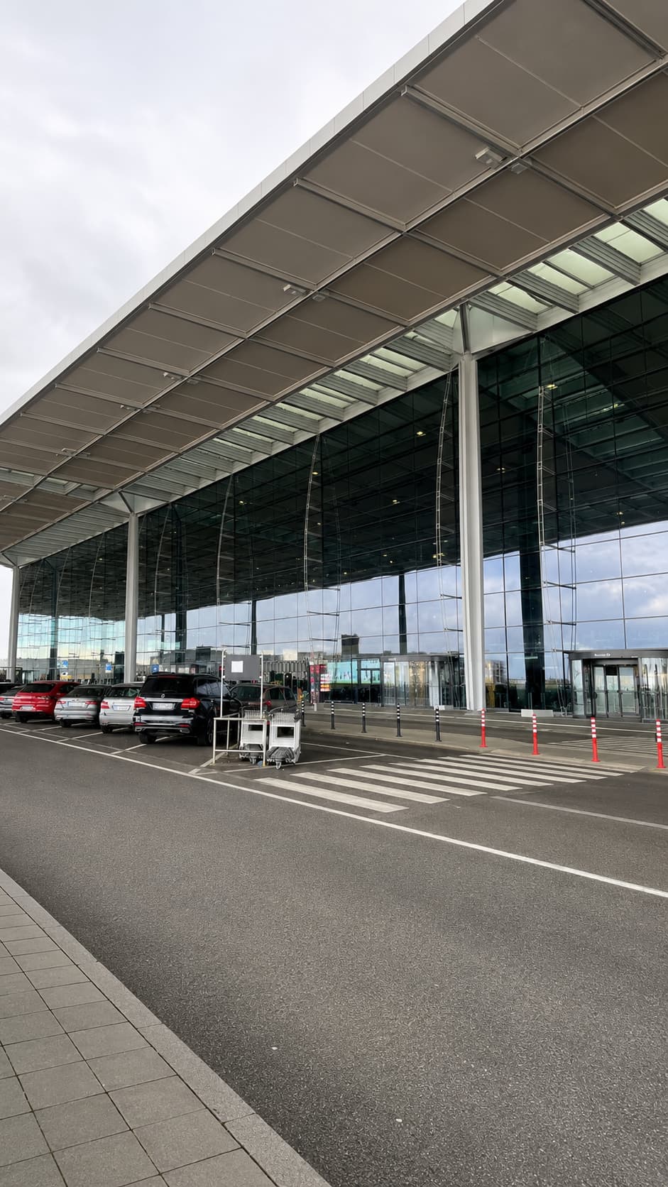 Quiet airport terminal exterior on an overcast day — the first stop on any solo trip