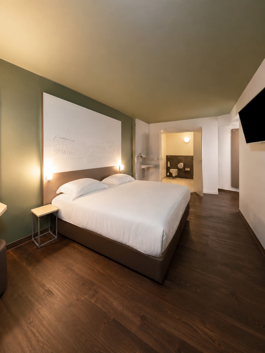 A solo hotel room with warm lighting and a double bed — the reality of the single supplement in solo travel