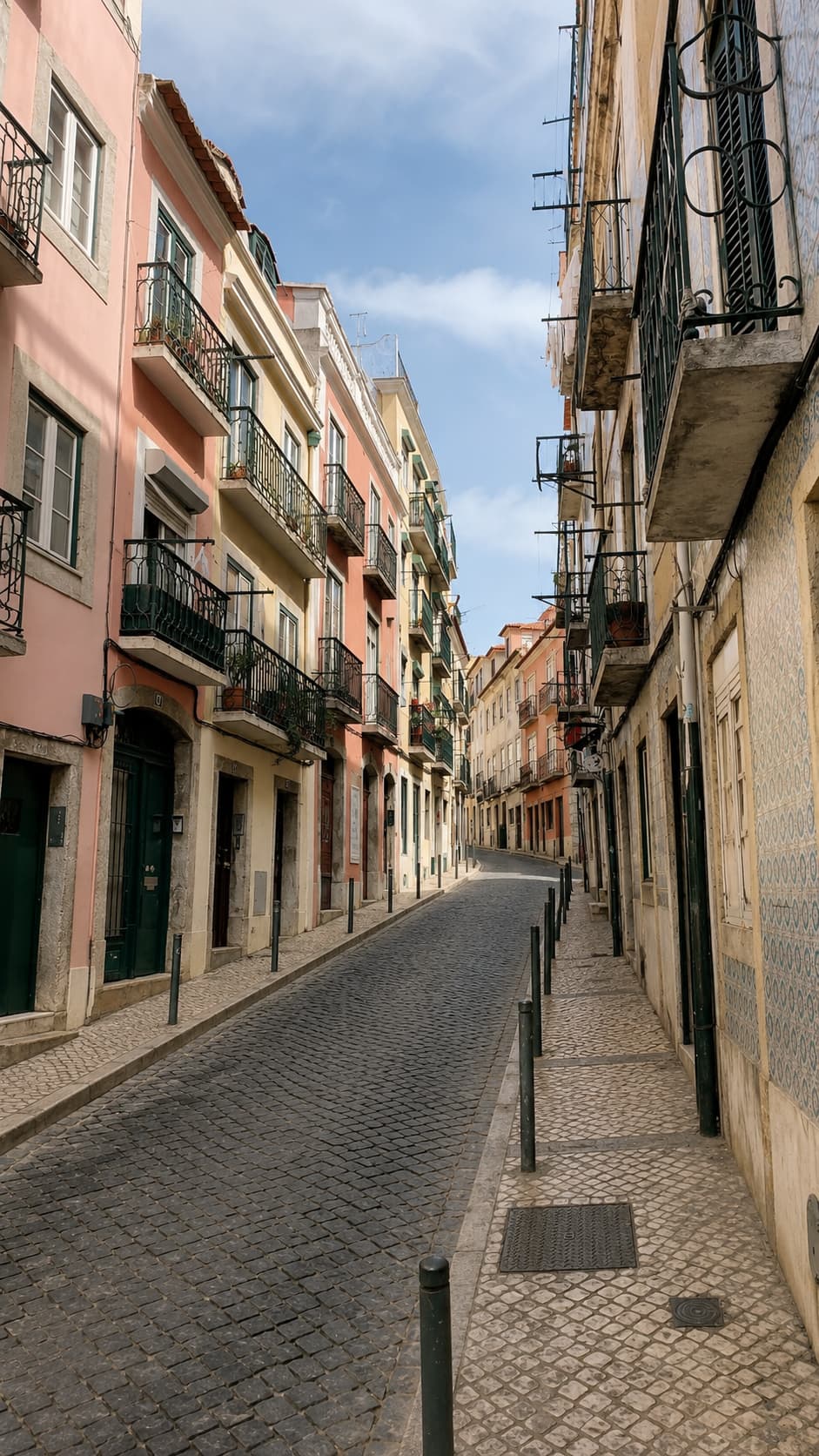 Empty cobblestone street in Lisbon with pastel buildings — one of the most solo travel tips-recommended cities in Europe