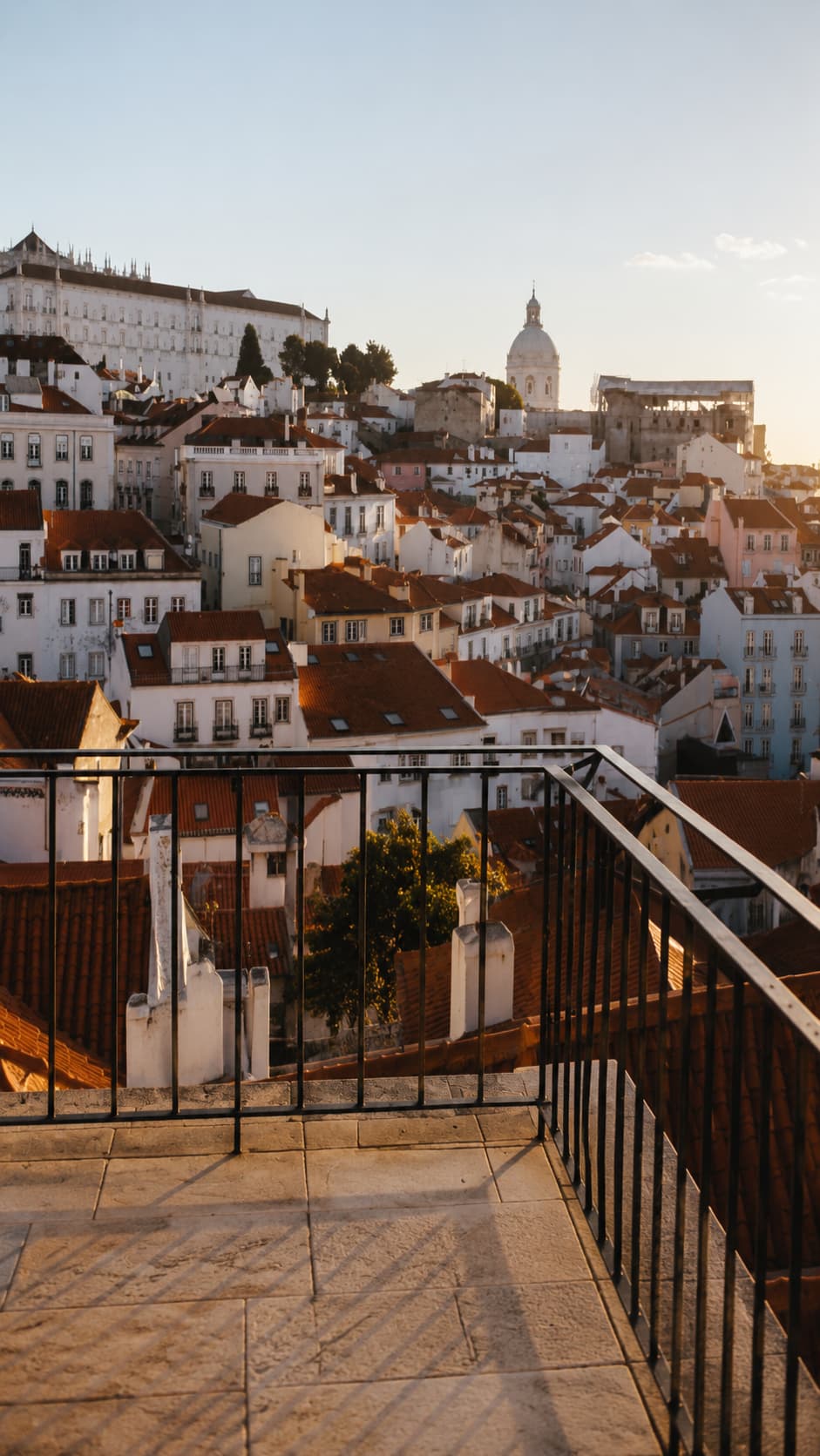 Sunrise over Lisbon's Alfama district seen from a miradouro viewpoint — the kind of moment solo travel tips can't fully prepare you for