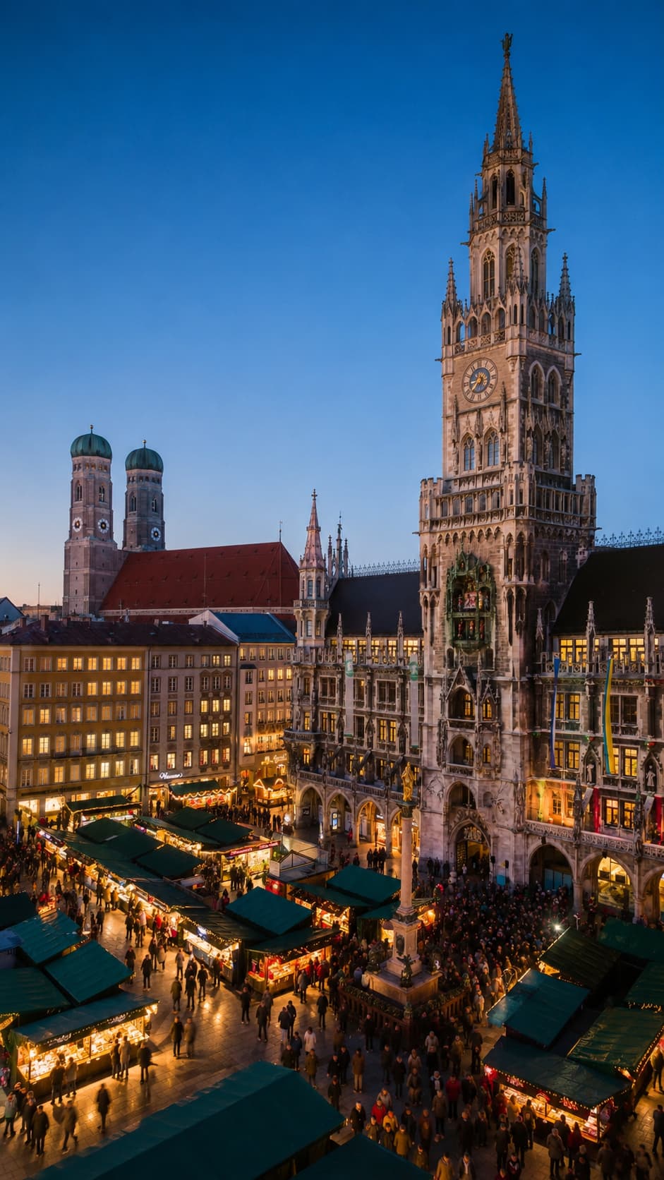 Munich Marienplatz Christmas market aerial at dusk, Neues Rathaus tower and Frauenkirche domes, green-roofed stalls