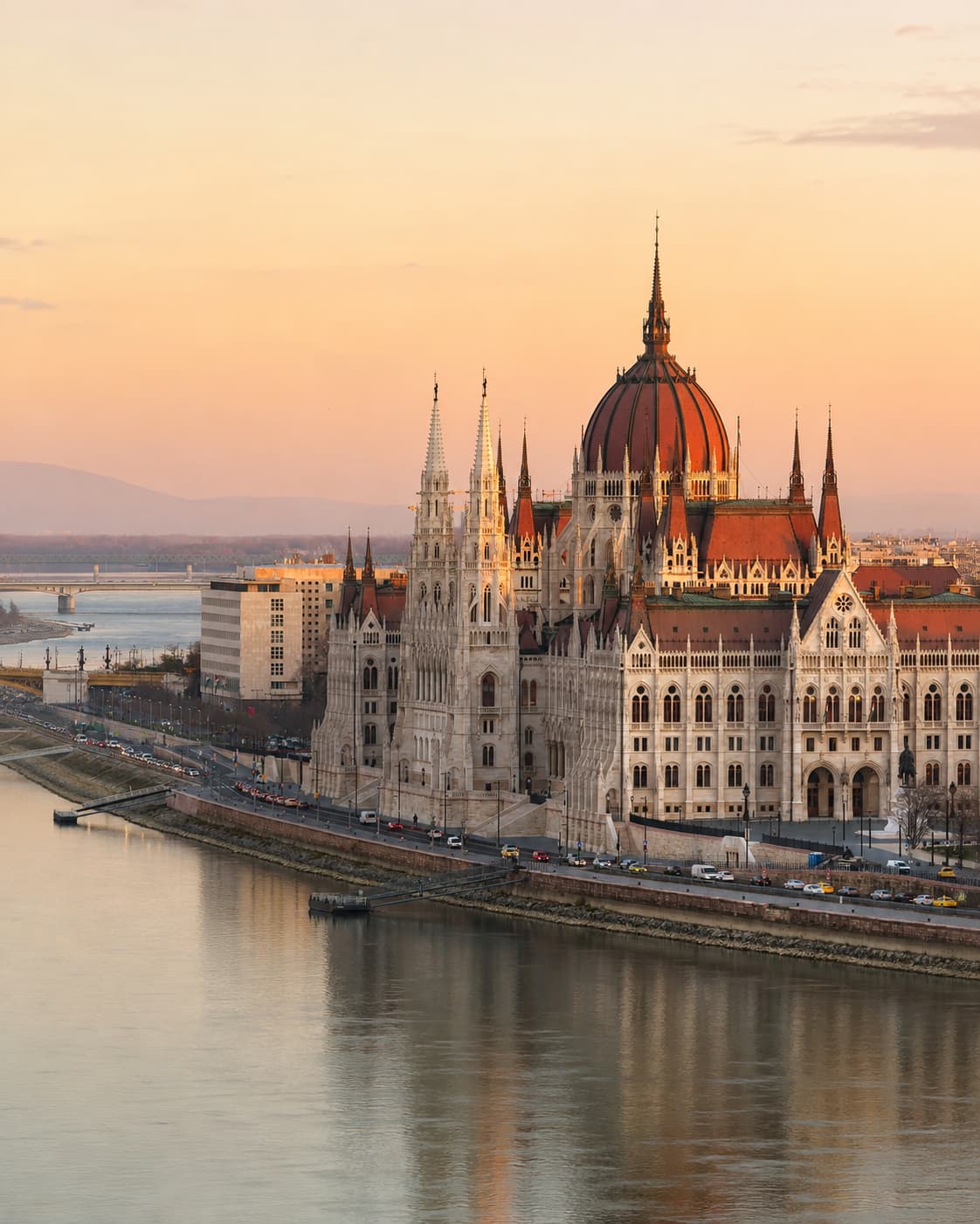 Budapest Parliament building at golden hour reflected in the Danube — Eastern Europe couples vacation idea