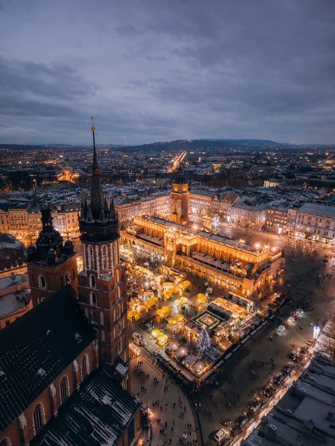 Krakow Rynek Glowny Christmas market aerial view at dusk with St Marys Basilica — European Christmas market open after Christmas Poland 2026