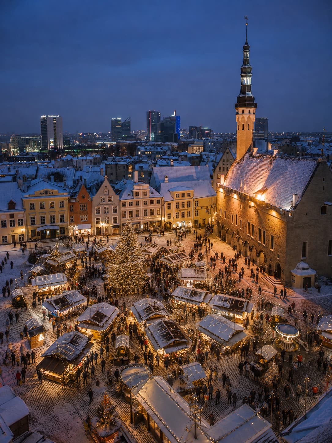 Tallinn Town Hall Square Christmas market aerial view in snow with medieval buildings — when do Christmas markets start in Europe Estonia Tallinn open November to January