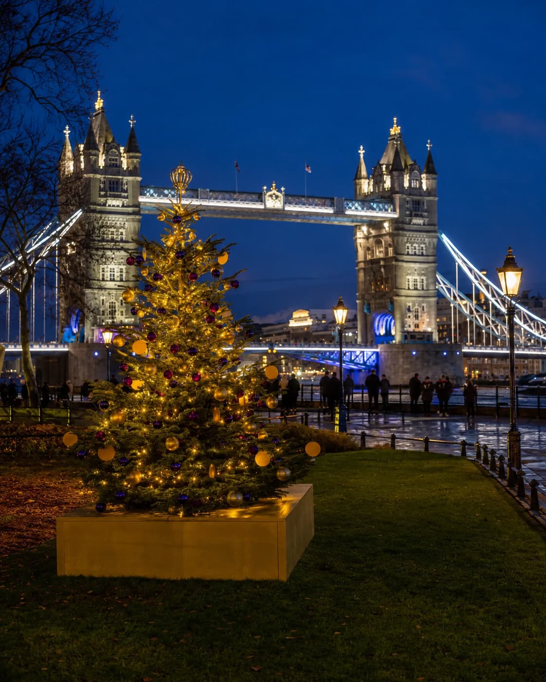 London Tower Bridge at night with decorated Christmas tree on the Thames riverbank — European Christmas markets UK London open mid-November 2026