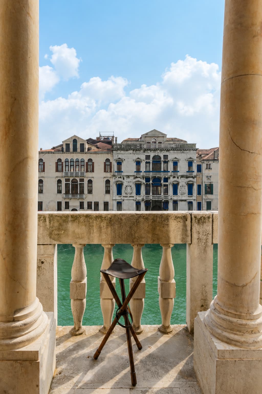 Venice Grand Canal viewed from a marble balcony with columns — a couples trip destination that suits the planner and the wanderer