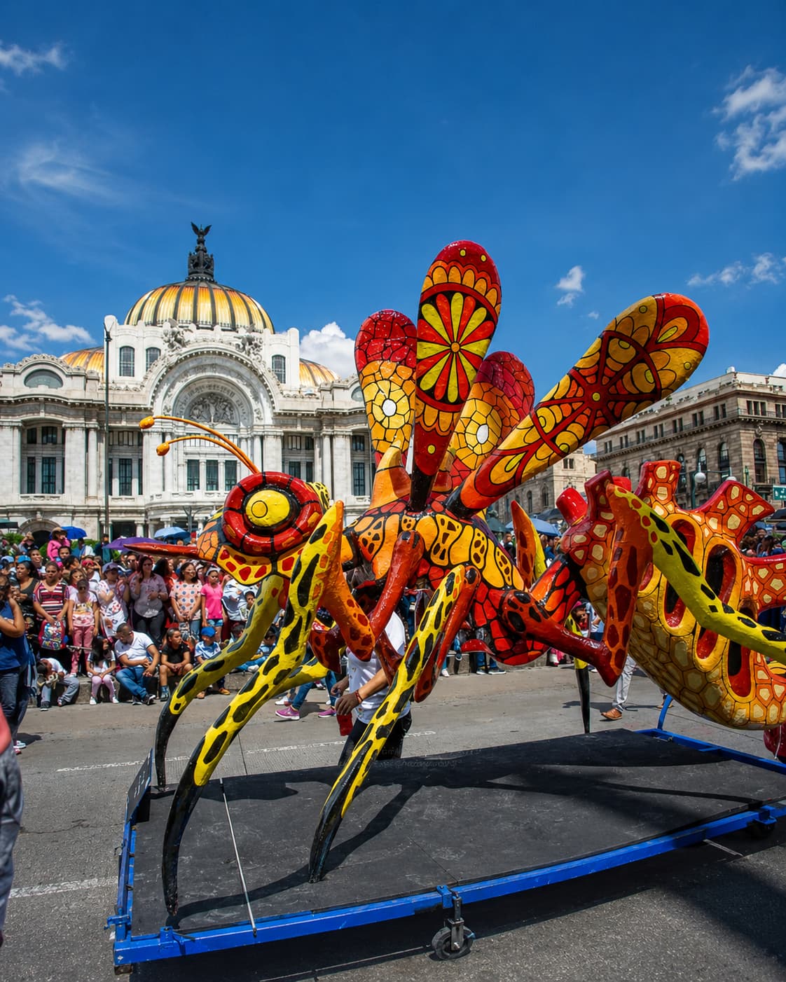Giant alebrije insect sculpture at the Mexico City Day of the Dead parade, Palacio de Bellas Artes in background