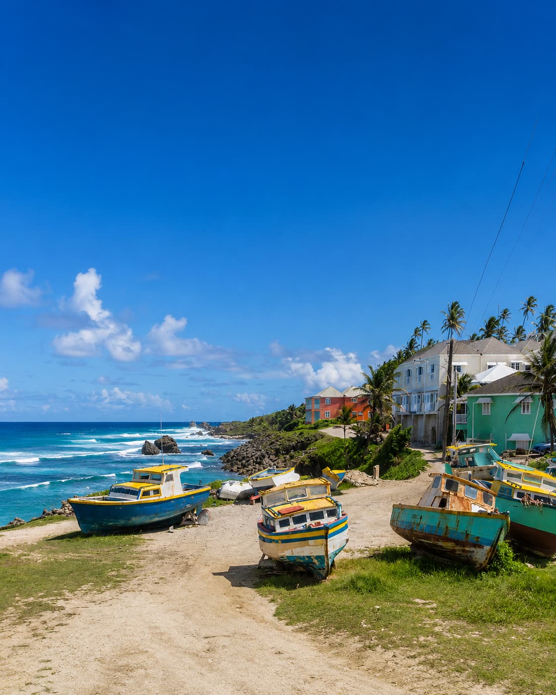 Colorful fishing boats on the shore of a Barbados village with turquoise Caribbean sea in December