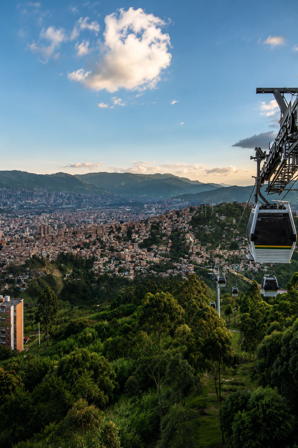 Medellín Colombia cable car (Metrocable) over the city in a green Andean valley — warm December destination in South America