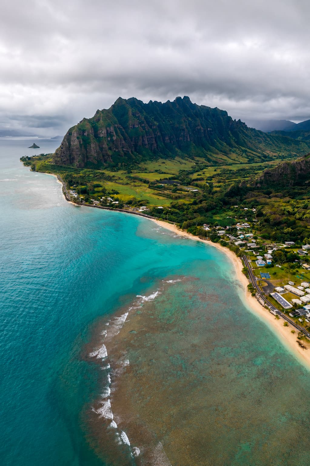 Aerial view of Kaneohe Bay, Oahu Hawaii — turquoise reef and volcanic ridgeline, warm in December