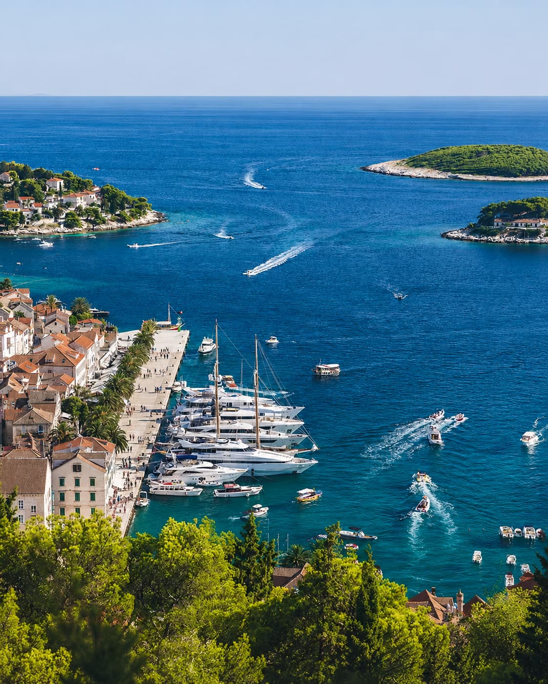 The harbour of Hvar, Croatia, packed with yachts and tourists in summer — the scene that coastal European destinations like this are not in November, when boats and restaurants largely close