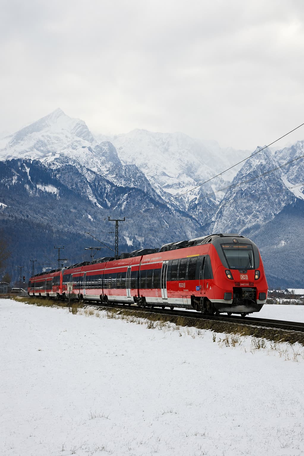 Deutsche Bahn regional train through snowy Alpine landscape — Bayern-Ticket route between Munich and Salzburg christmas markets
