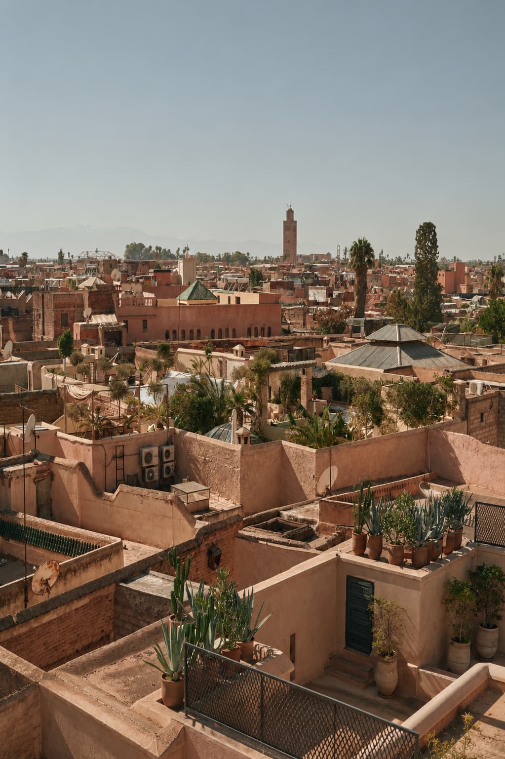 Marrakech medina rooftop panorama with the Koutoubia minaret rising above terracotta rooftops — November is the best month for Thanksgiving travel abroad to Morocco
