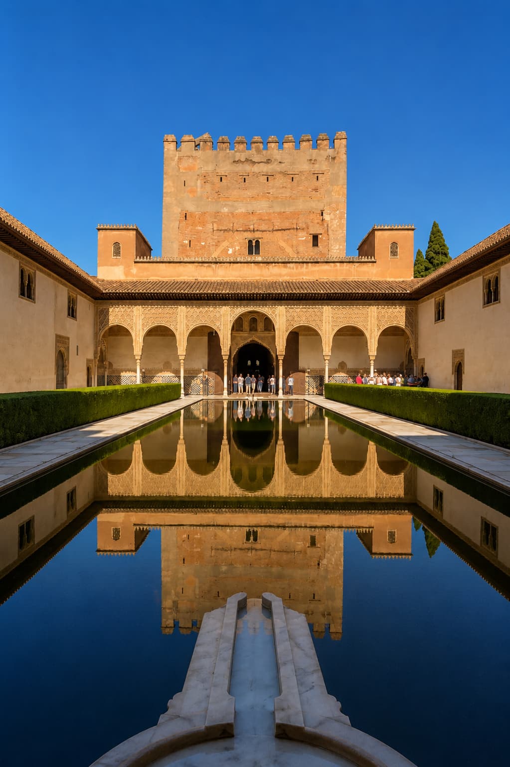 Alhambra Nasrid palaces — Court of the Myrtles reflecting pool with ornate arched colonnade, Granada, Spain