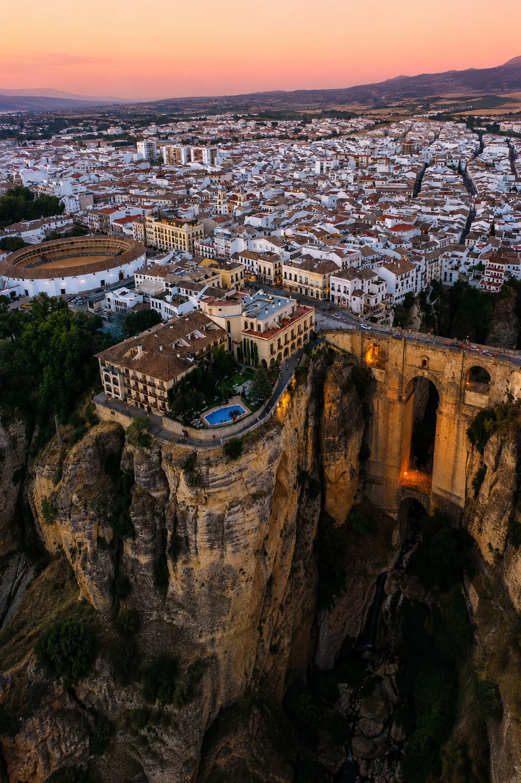Ronda Puente Nuevo bridge — dramatic aerial view over the Tajo gorge at dusk, Andalusia in autumn