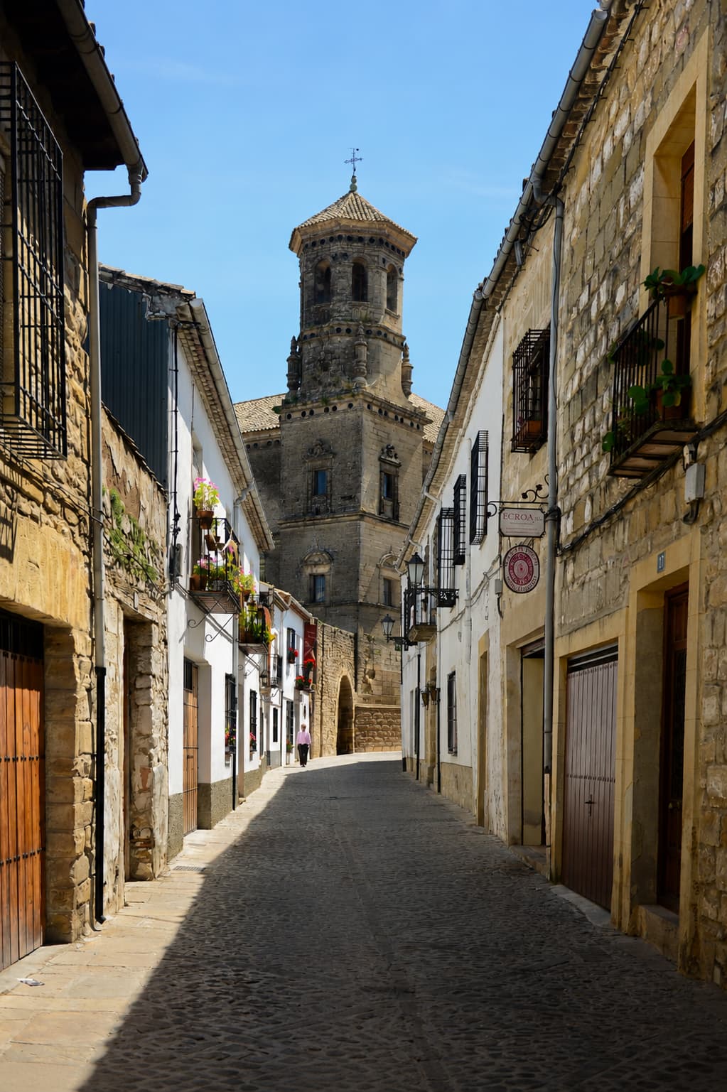 Cobblestone street leading to a Renaissance church tower in Úbeda, Jaén province, southern Spain