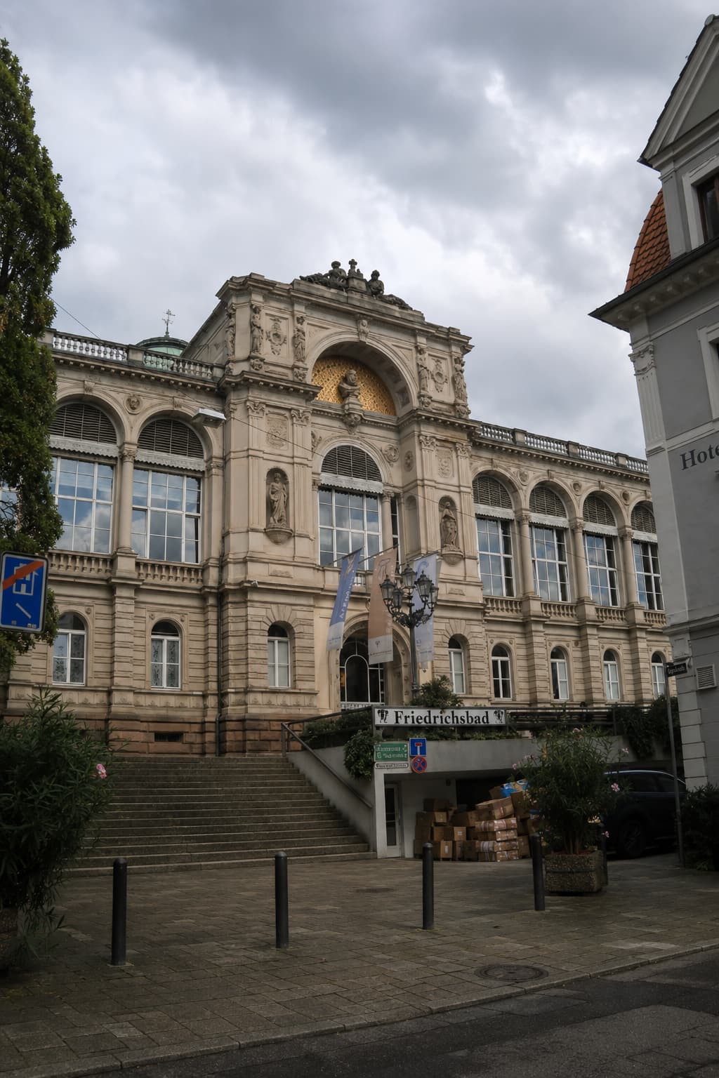 Friedrichsbad thermal bath exterior in Baden-Baden, Germany — one of the best spa towns in Europe, with ornate neoclassical stonework and arched windows under a cloudy sky