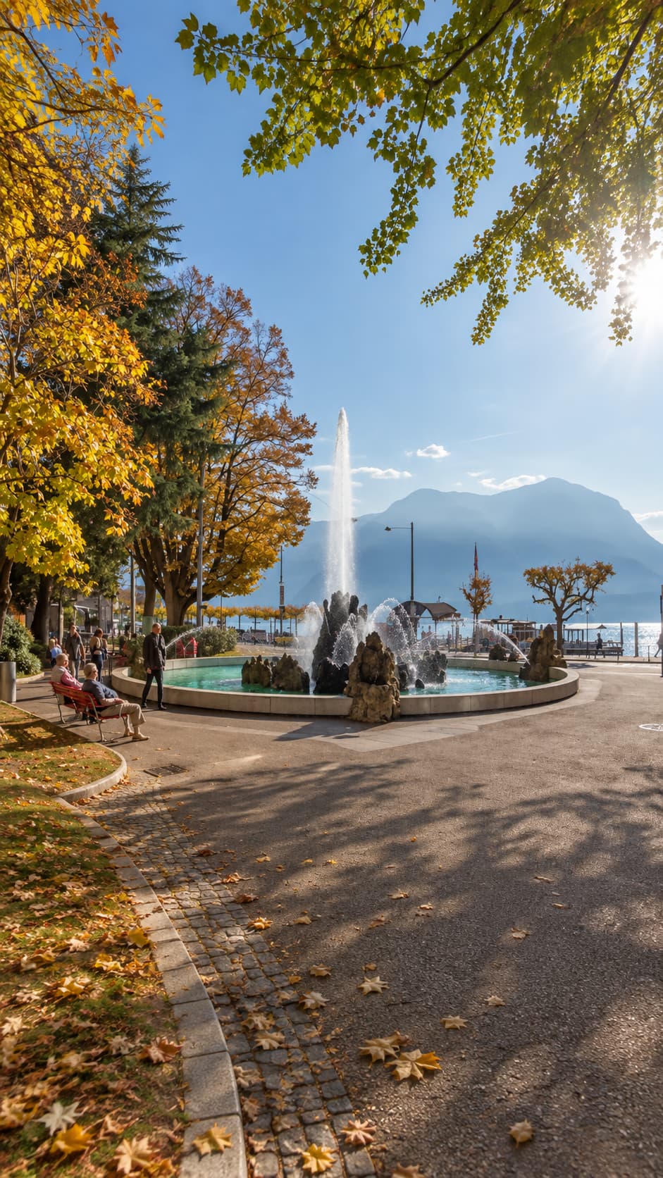 Golden leaves and fountain on the Locarno lakefront in Ticino in autumn