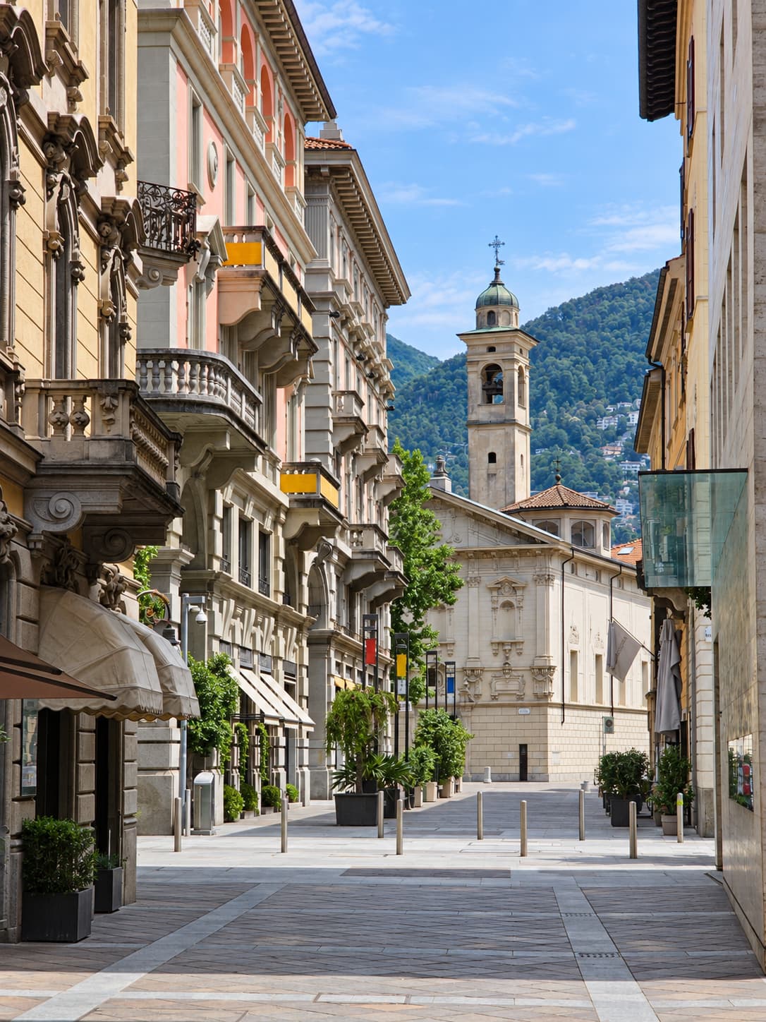 Lugano's pedestrian old town with Italian-style architecture and the cathedral tower