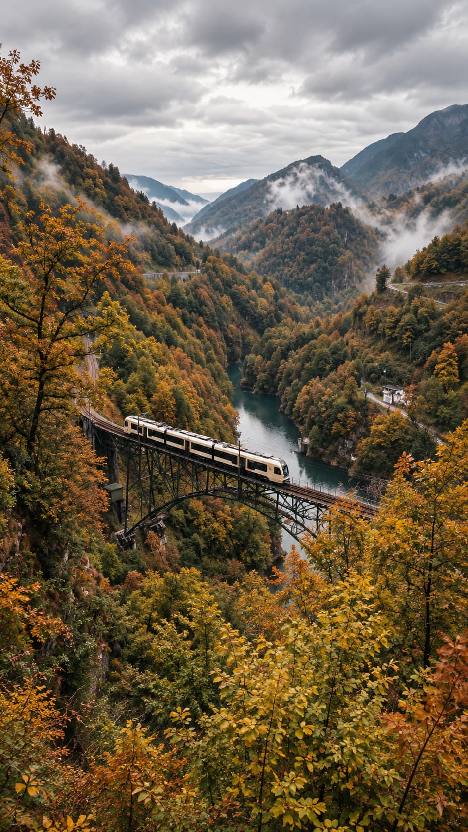 The Centovalli Railway crossing a viaduct above an emerald river through October forest