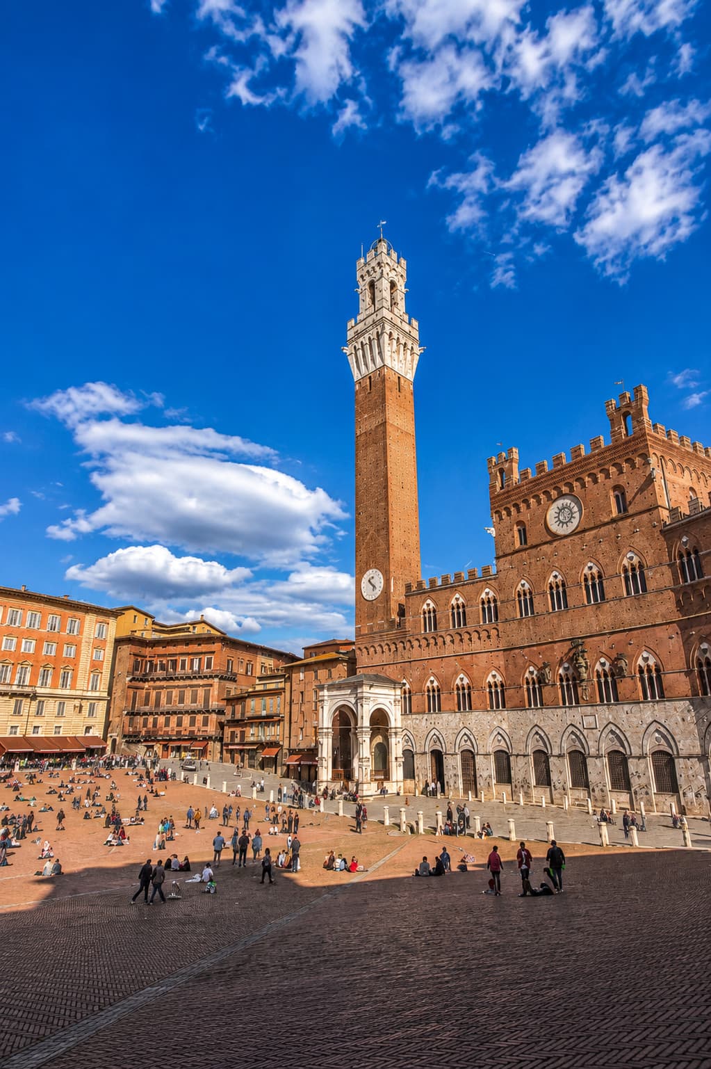 Siena's Piazza del Campo and the Torre del Mangia under a clear sky, far less crowded than in summer