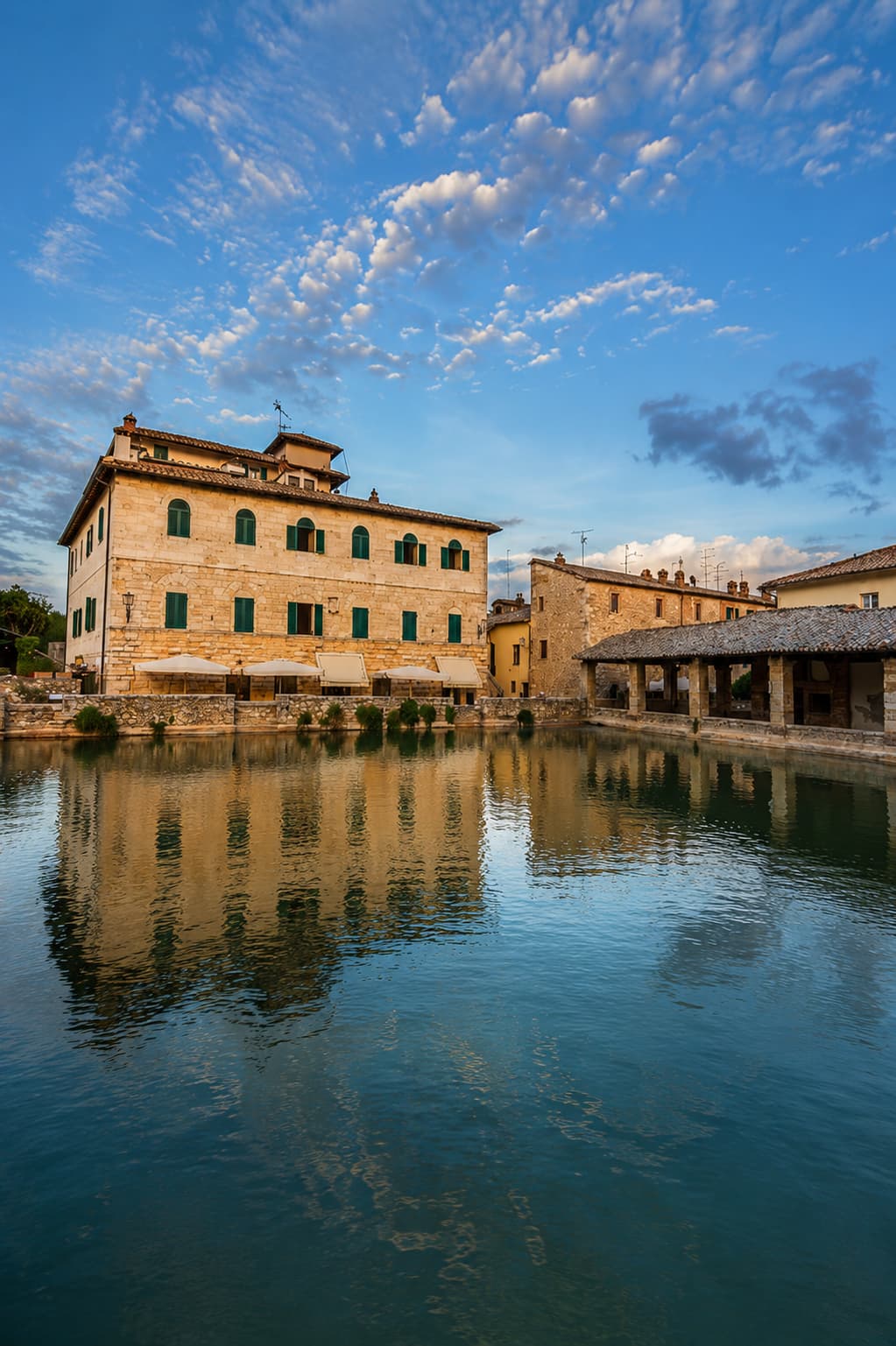 The thermal pool at the center of Bagno Vignoni's square, a still corner of Tuscany in autumn